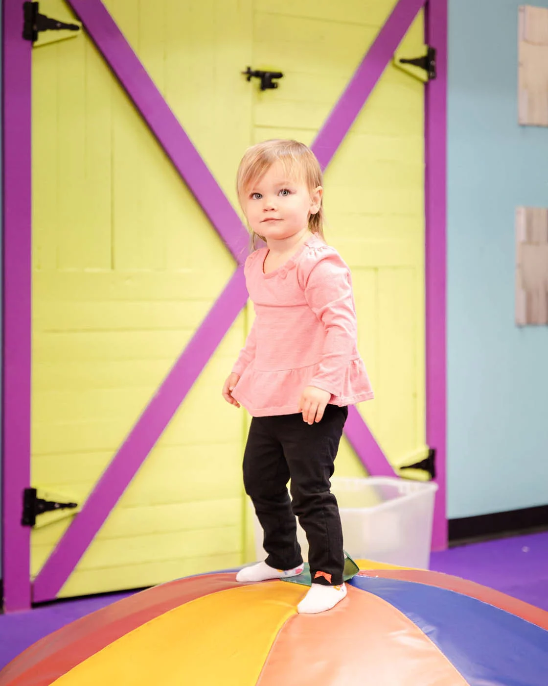 little girl playing in gym at Romp n' Roll.