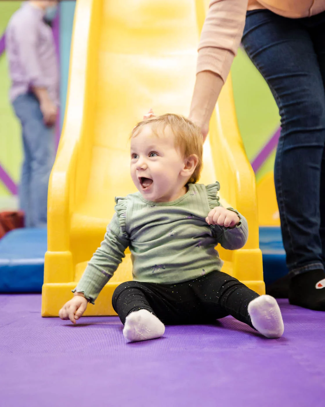 A little baby playing at a Romp n' Roll, VA gym.