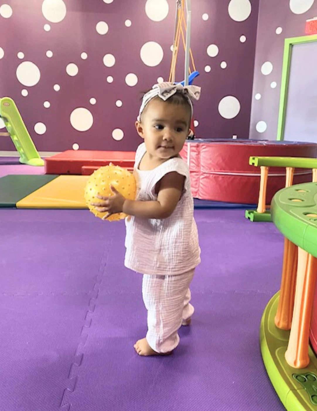 A little girl playing at Romp n' Roll kids gym.