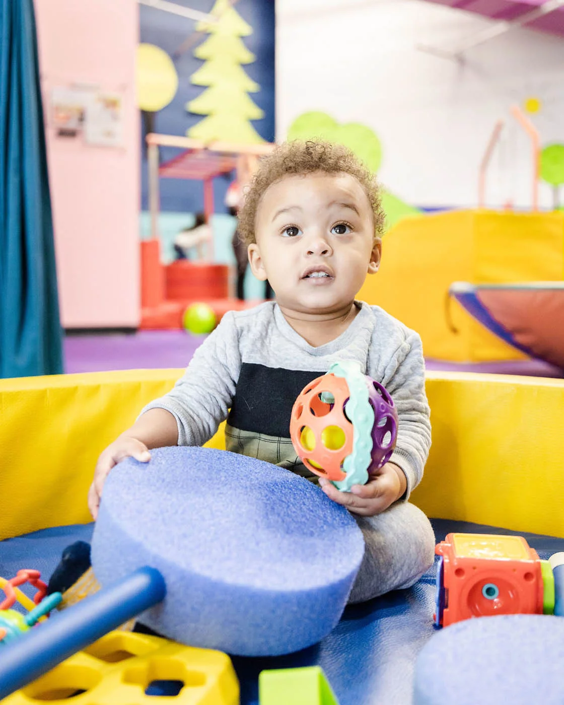 A young boy playing at Romp n' Roll's gym.