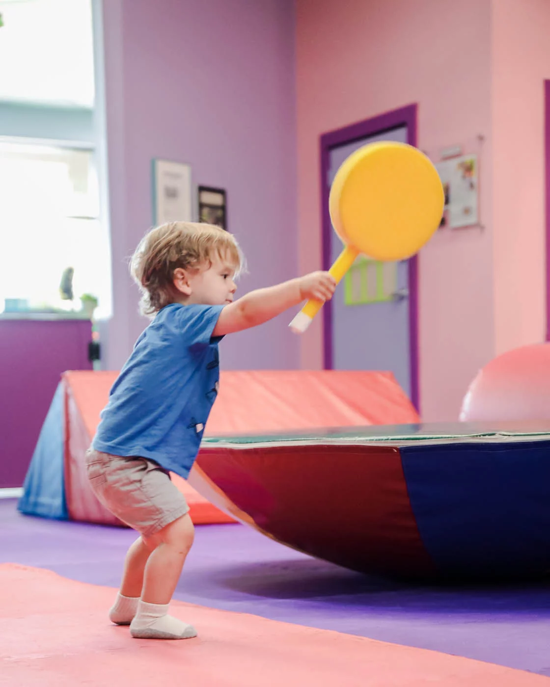 Romp n' Roll little boy playing racket tennis. 