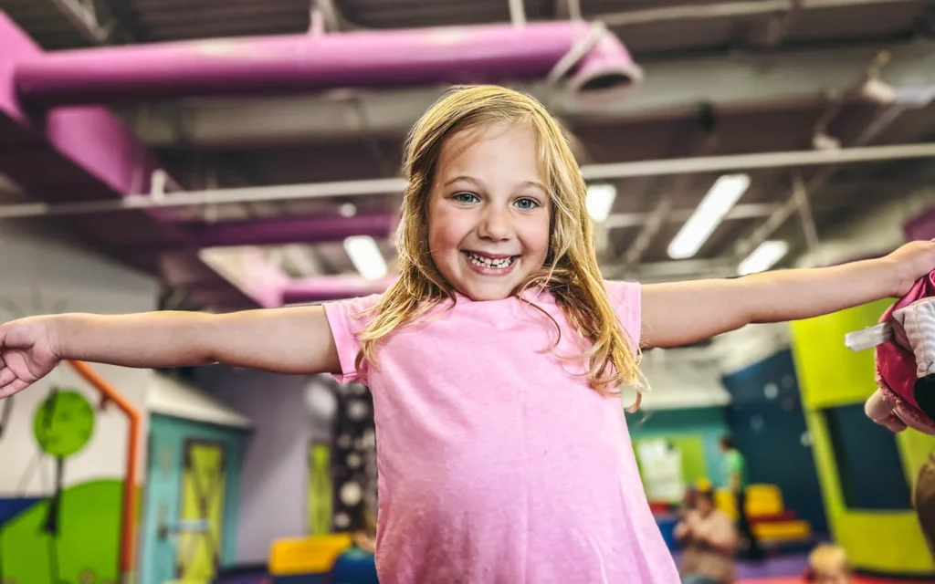 An about 5 year old girl playing in Romp n' Roll's gym.