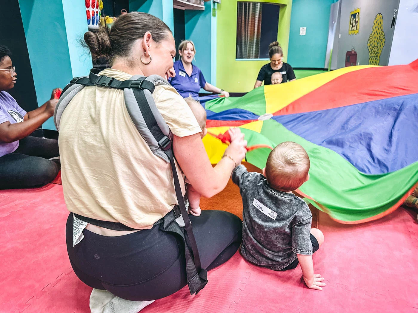 A group of small children with an instructor learning and playing together in a socialization class for kids