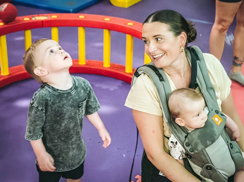 A little boy playing at a Romp n' Roll class with one of our team members.