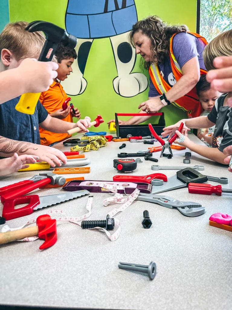 Romp n' Roll hosting a building class for a summer camp for kids.