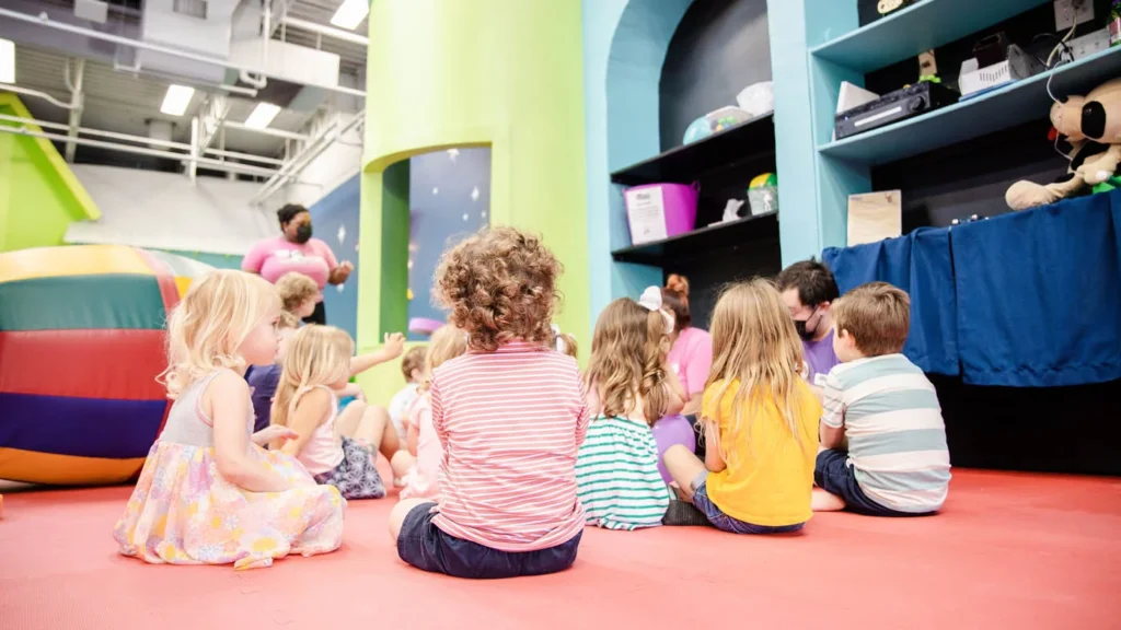 A group of kids learning from an instructor at Romp n' Roll - our kids entertainment franchise.