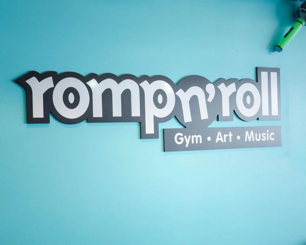 A Romp n' Roll sign outside a childrens fitness franchise class.