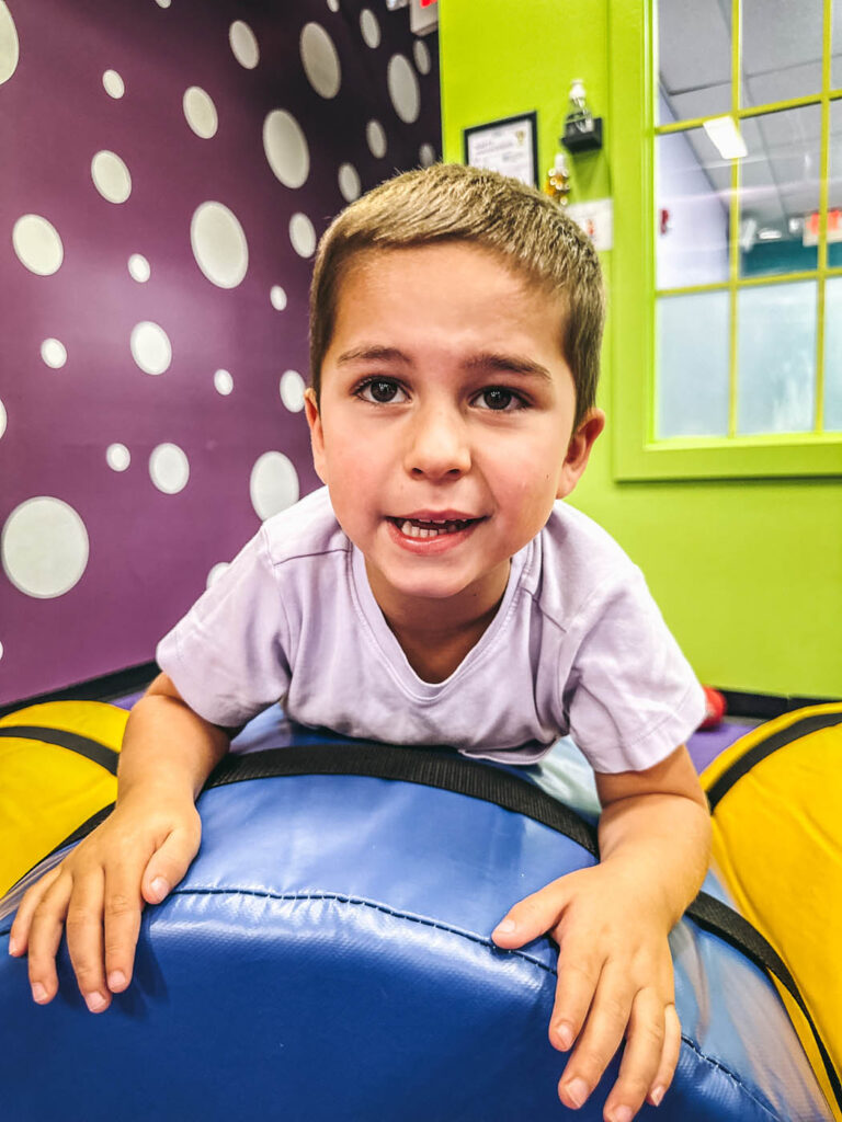 An older boy at Romp n' Roll enjoying preschool classes.