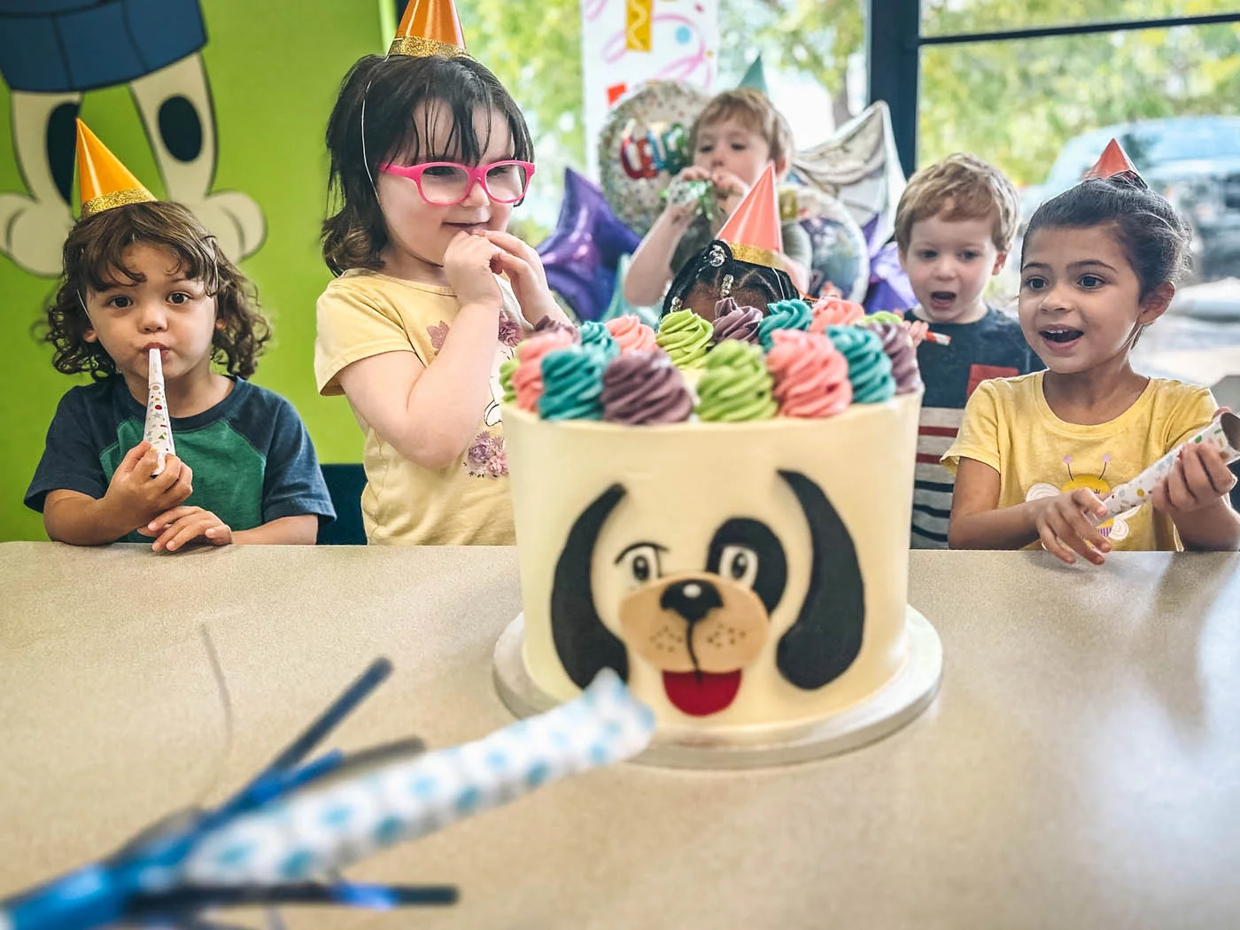 A girl at her party with friends at a Rompy cake - birthday and special events held at Romp n' Roll.